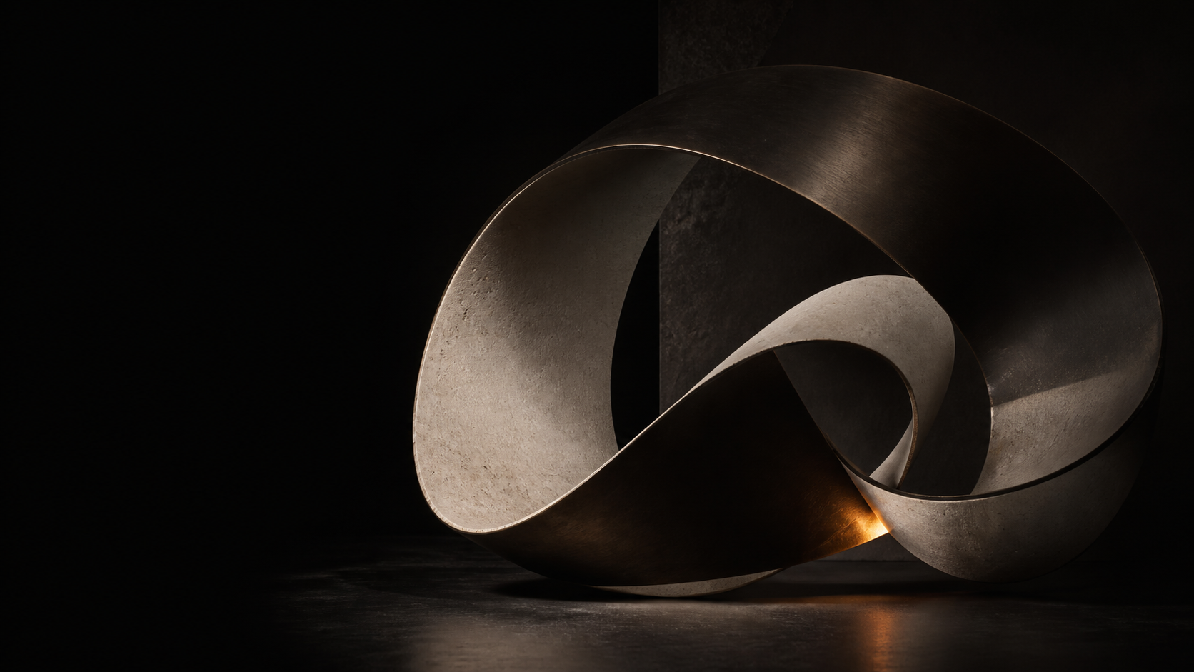 Abstract ribbon sculpture in limestone and dark metal